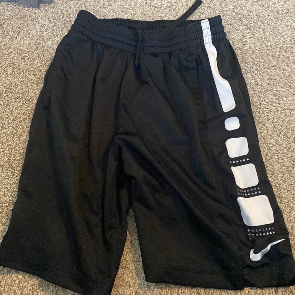 Black NIKE basketball shorts, dri-fit material, kids size large.
